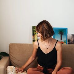 Pet parent with her cat on the sofa